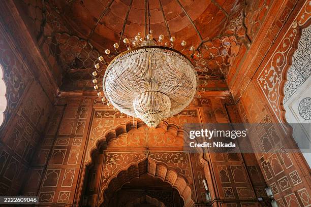 intricate chandelier inside jama masjid's ornate interior in old delhi, india - condition stock pictures, royalty-free photos & images