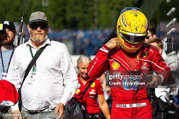 Lewis Hamilton of Great Britain and Ferrari walks in the paddock in his race suit during qualifying ahead of the F1 Grand Prix of Austria at Red Bull...