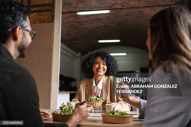 professional team sharing midday meal, bonding over casual lunch while fostering workplace connection and collaborative spirit - lunch stock pictures, royalty-free photos & images
