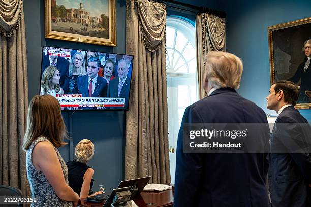 In this handout provided by the White House, U.S. President Donald J. Trump and U.S. Secretary of State Marco Rubio watch a television screen as U.S....