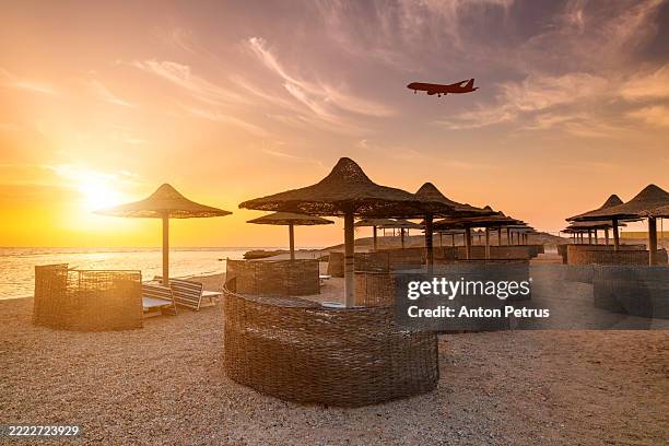 airplane over the beach in egypt at sunset. red sea - sharm el sheikh stock pictures, royalty-free photos & images