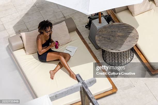 smiling woman relaxing on poolside - throw pillow white stock pictures, royalty-free photos & images
