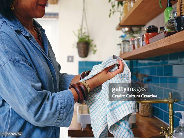 woman washing hands in kitchen, close up - dish towel stock pictures, royalty-free photos & images