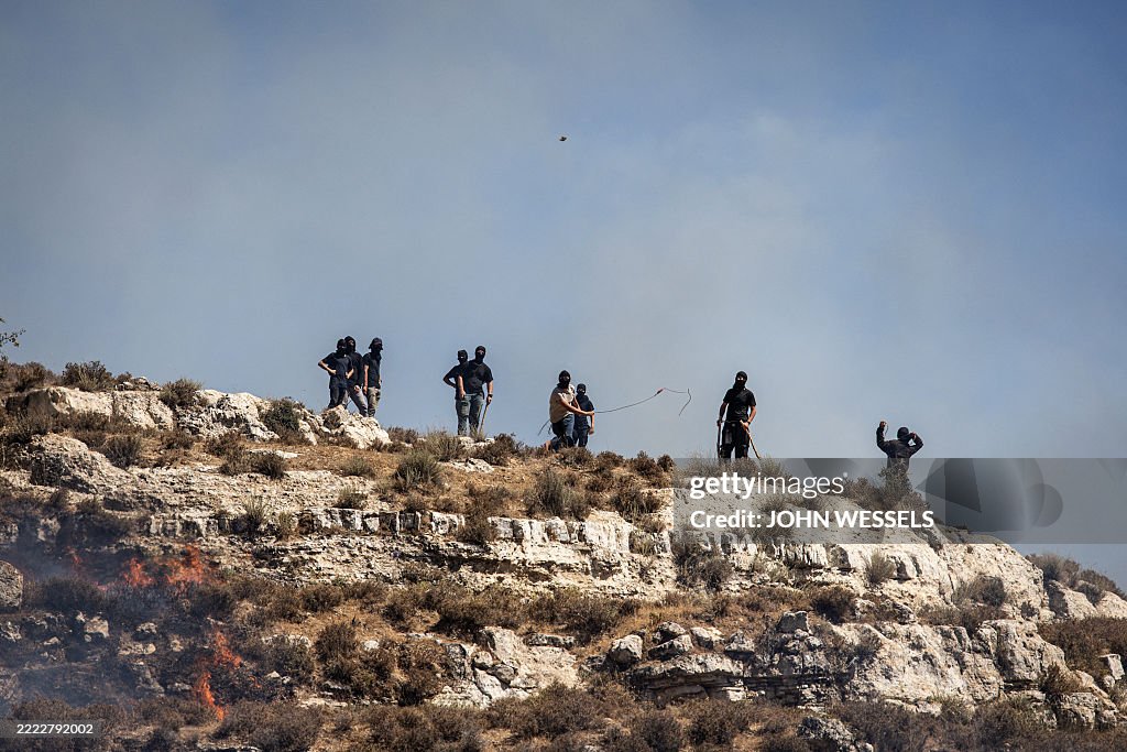 Hurled Rocks Masked Israeli settlers hurl rocks at Palestinians from hilltop in ...