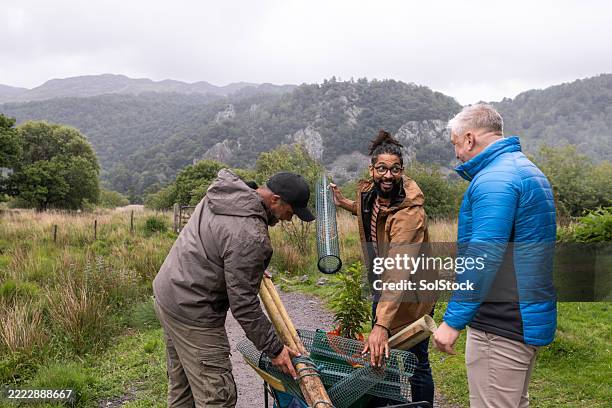 eco-conscious men in nature conservation - environmentalist stock pictures, royalty-free photos & images