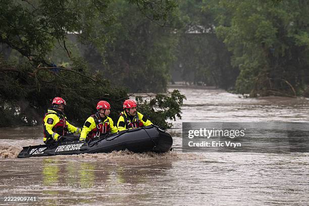 Boerne Search and Rescue teams navigate upstream in an inflatable boat on the flooded Guadalupe River on July 4, 2025 in Comfort, Texas. Heavy...