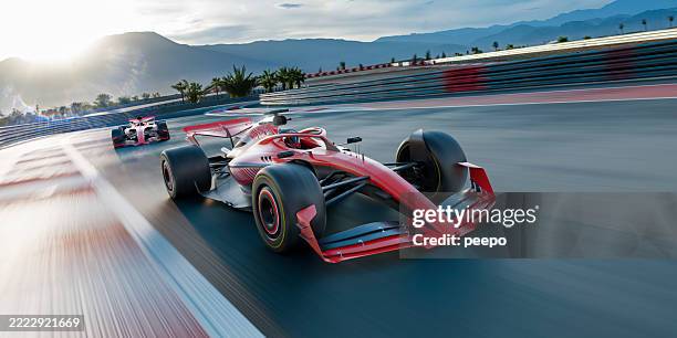 two racing cars moving at high speed along track - racewagen stockfoto's en -beelden