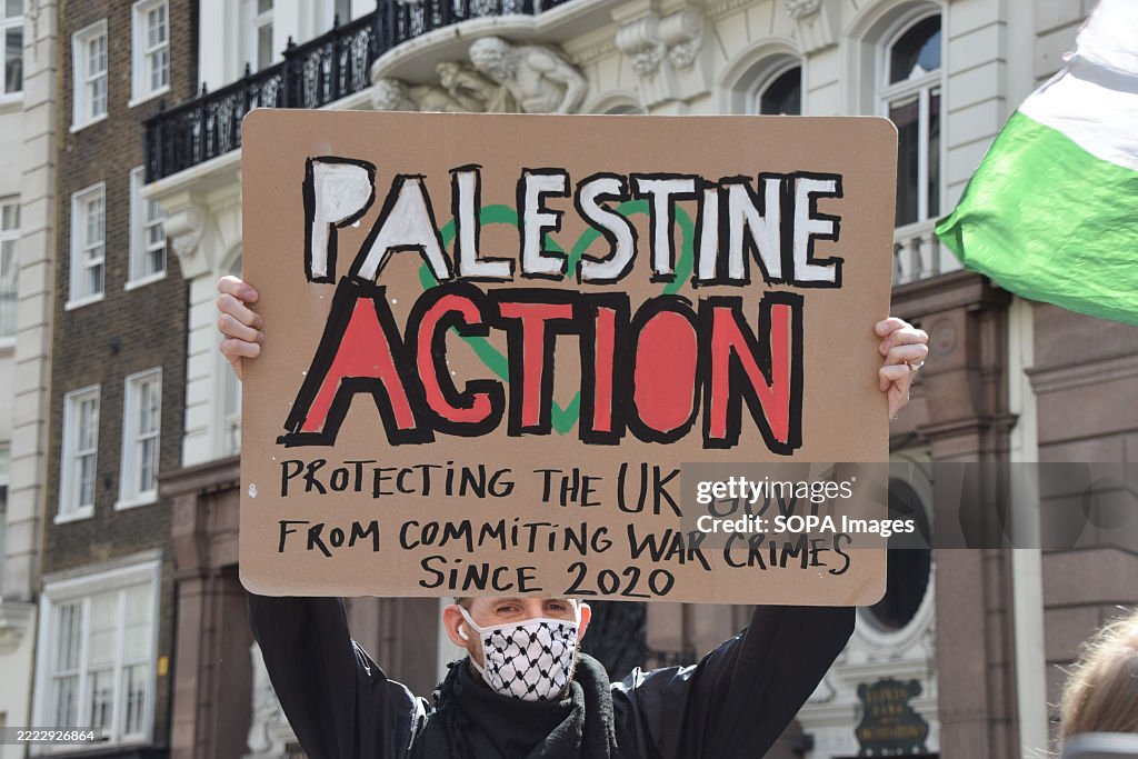 Protestet A protester holds a placard in support of Palestine Action during the ...