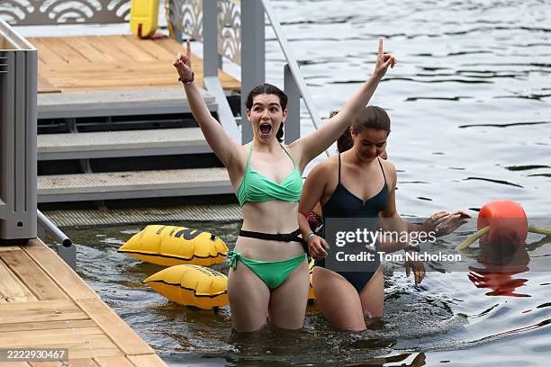 Swimmers react before entering the Baignade Bras Marie bathing site in the river Seine during its opening day on July 5, 2025 in Paris, France. Mayor...