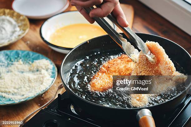 frying crispy chicken in a cooking pan for japanese katsu curry - cutlet stock pictures, royalty-free photos & images