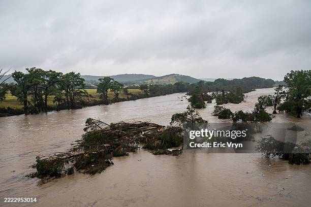 Trees emerge from flood waters along the Guadalupe River on July 4, 2025 in Kerrville, Texas. Heavy rainfall caused flooding along the Guadalupe...