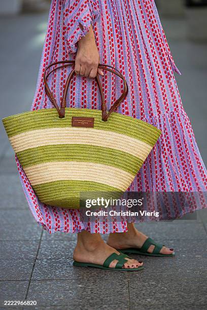 Victoria Scheu wears pink striped chiffon maxi summer dress Evarae, maxi striped basket bag Sezane, Hermes Oran sandals in green during Berlin...