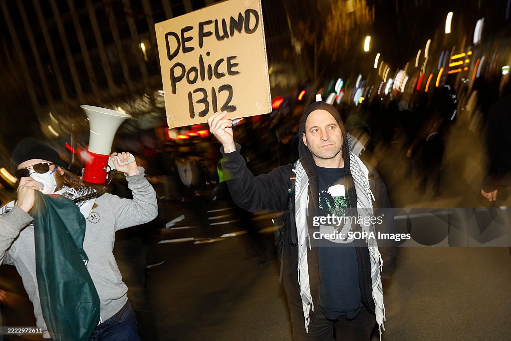 Protestet A protester holds a placard during the demonstration. Protesters ...