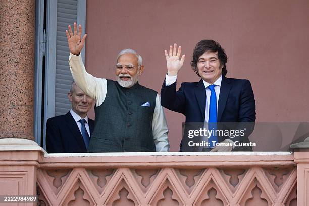 Prime Minister of India Narendra Modi and President of Argentina Javier Milei wave from the Argentine Government house balcony during an official...
