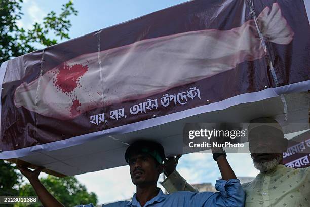 Members of the Bangladesh Republic Party hold a symbolic shroud procession in front of the National Museum at Shahbagh in Dhaka, Bangladesh, on July...