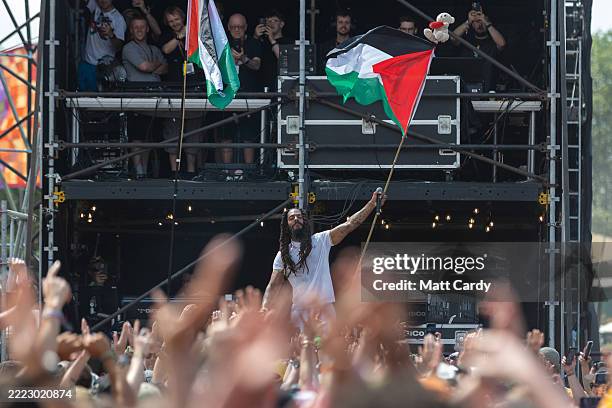 Bob Vylan waves a Palestinian flag as he performs on the West Holts stage during day four of Glastonbury Festival 2025 at Worthy Farm, Pilton on June...