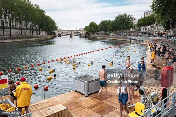 People swim at the Pont Marie safe bathing site on the Seine River on its opening day, in Paris, France, on July 5, 2025. The River Seine reopens to...