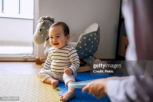 cute playful baby girl having fun with her mother at home - babyhood stock pictures, royalty-free photos & images