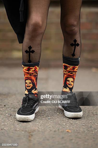 Ozzy Osbourne-themed socks worn by music fan Jen Sanchez as she arrives to attend British rock band Black Sabbath's "Back to The Beginning" concert,...
