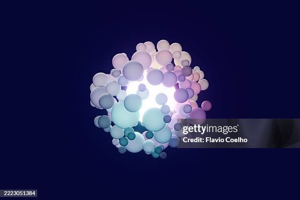 cluster of digital spheres orbiting a radiant core - complex math stock pictures, royalty-free photos & images
