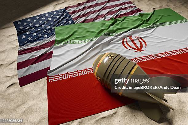 nuclear bomb, american and iranian flags resting on desert sand - conflict stock illustrations