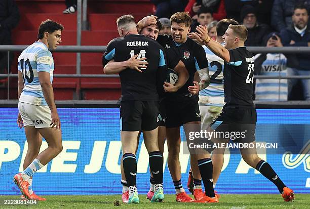 England's wing Cadan Murley celebrates with teammates after scoring a try during the international rugby test match between Argentina and England at...