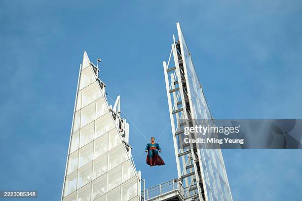 An 11ft sculpture of Superman is seen suspended at the top of The Shard on July 1, 2025 in London, England.