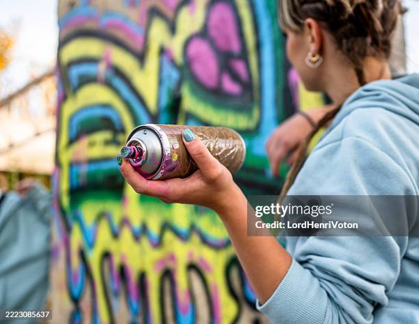 street artist holding spray can creating graffiti art - graffiti bildbanksfoton och bilder