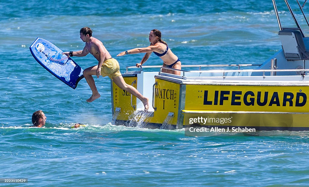 Beach Rescue Lifeguard Newport Beach Lifeguard Tyler Duss, left, assists as a fellow Newport ...