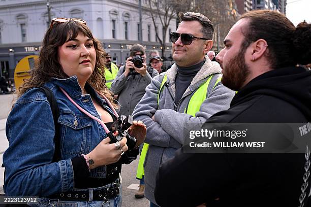 Local Israeli security block a photographer at a rally in Melbourne on July 6 after the front door of a synagogue was set ablaze on July 4. A man...