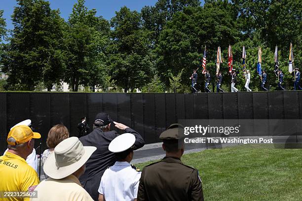 Military Color Guard marches atop the wall at the Vietnam Veterans Memorial during a ceremony, on Memorial Day, May 26, 2025 in Washington.