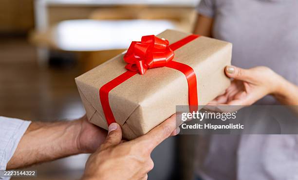 close-up on a person giving a gift to another one - gift stock pictures, royalty-free photos & images