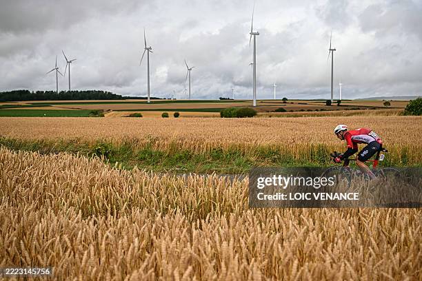 Lotto team's Belgian rider Brent Van Moer cycles in a breakaway past wheat fields and wind-turbines during the 2nd stage of the 112th edition of the...