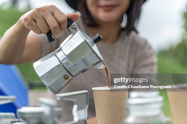 pouring fresh coffee while camping - disposable cup stock pictures, royalty-free photos & images