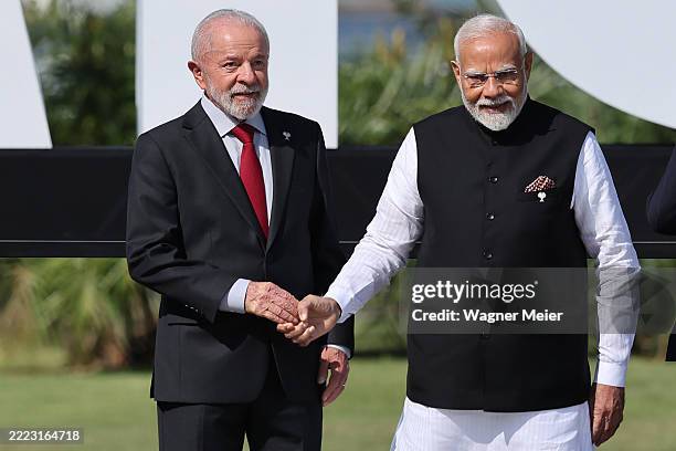Brazil's President Luiz Inacio Lula da Silva shake hands with India's Prime Minister Narendra Modi during the family photo as part of the Brics...