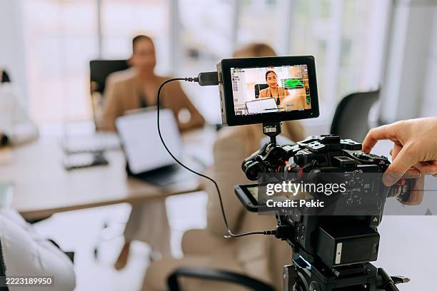 successful business team discussing strategy while filming staff meeting in the board room with dslr camera - filming stock pictures, royalty-free photos & images