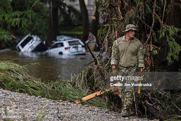 Search and rescue worker looks through debris for any survivors or remains of people swept up in the flash flooding on July 6, 2025 in Hunt, Texas....