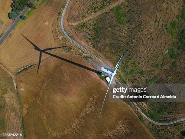 imagen aérea de un aerogenerador visto desde arriba con su sombra en el suelo, en portugal - escena de tranquilidad fotografías e imágenes de stock