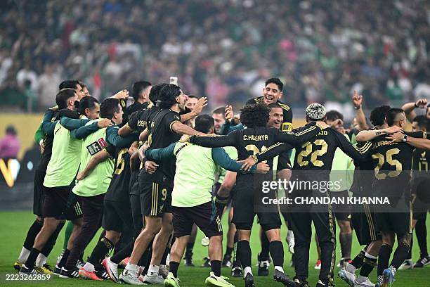 Mexico's players celebrate their team's victory at the end of the Concacaf Gold Cup final football match between Mexico and USA at NRG Stadium in...