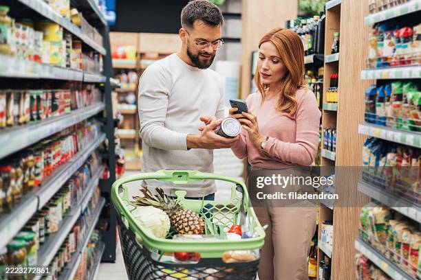 couple shopping in supermarket. - buy online pick up in store stock pictures, royalty-free photos & images