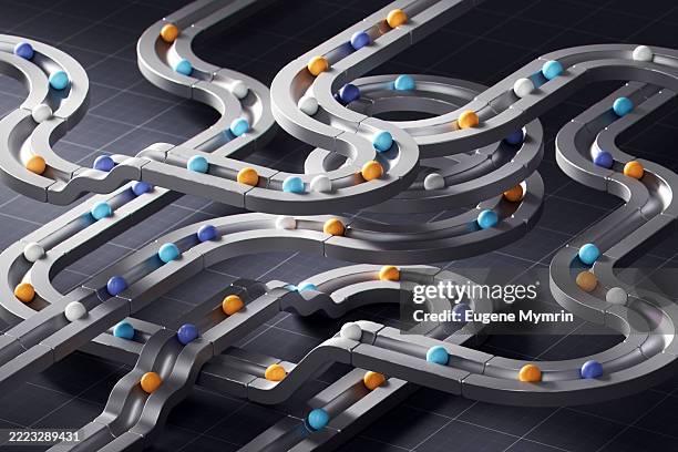 complex network of interconnected tracks transporting colorful spheres, symbolizing data flow and financial transactions - single lane road stock pictures, royalty-free photos & images