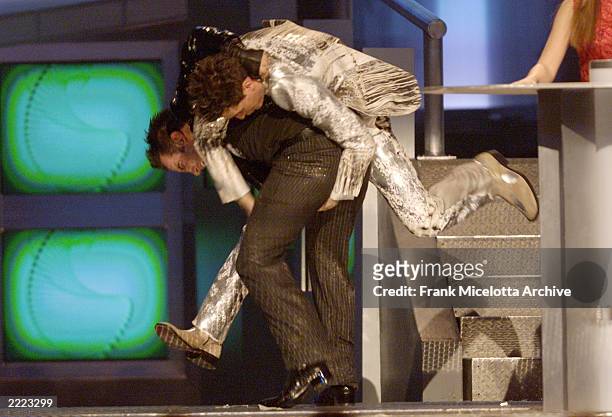 Sync's Chris Kirkpatrick, bottom, and JC Chasez wrestle during the 2000 Billboard Music Awards at the MGM Grand Hotel and Casino, Las Vegas, NV,...