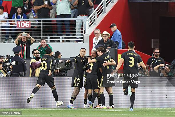 Raul Jimenez of Mexico celebrates with his teammates after scoring the team's first goal during the Gold Cup Semi Finals match between Mexico and...