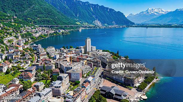 aerial view of montreux waterfront on lake geneva surrounded by the swiss alps, panoramic cityscape with luxury hotels and residential buildings, travel and tourism concept for european lake destinations - geneva switzerland stock pictures, royalty-free photos & images