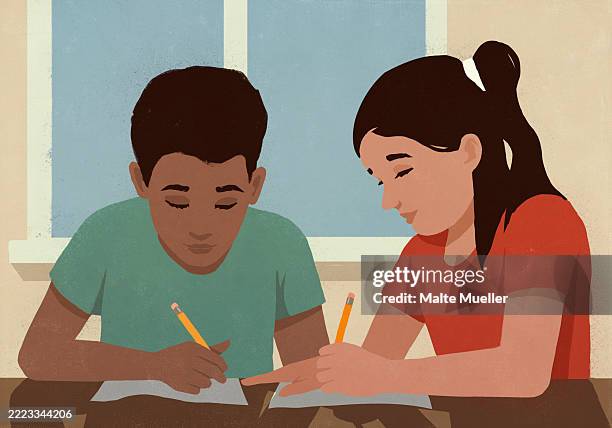 Multiracial Students Doing Homework Next To Each Other In Classroom ...