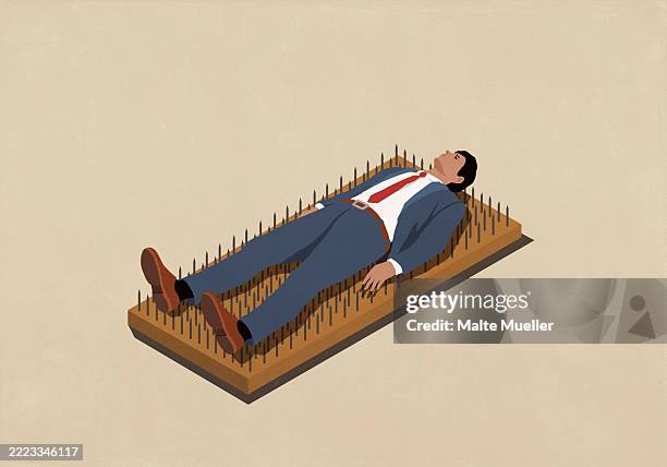 businessman laying on bed of nails against beige background - laying on bed of nails stock illustrations