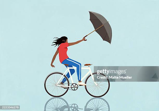 wind pulling woman riding bicycle with umbrella on blue background - i can do it stock illustrations