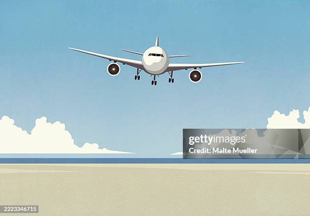 airplane flying low over sunny summer ocean beach - aerospace landing gear stock illustrations