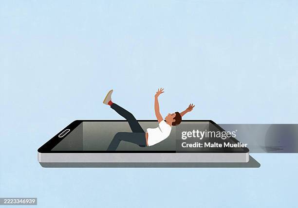 surprised man falling backward into smart phone screen against blue background - männlicher teenager stock-grafiken, -clipart, -cartoons und -symbole