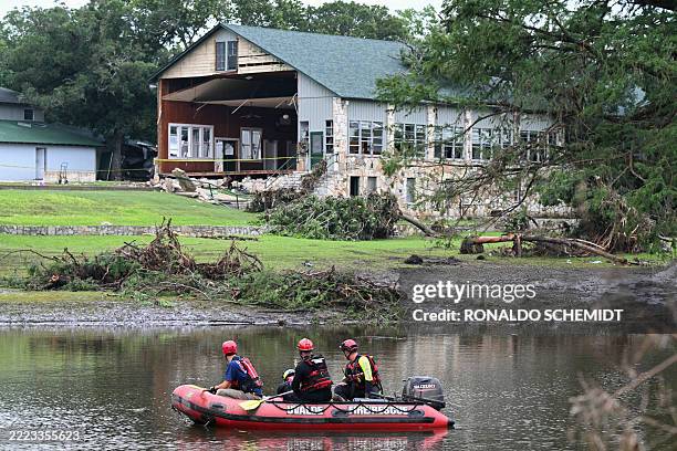 Search and rescue team looks for people along the Guadalupe River near a damaged building at Camp Mystic in Hunt, Texas, on July 7 following severe...